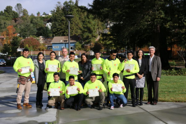 Young people holding certificates; First Graduating Class of E2C Construction Program