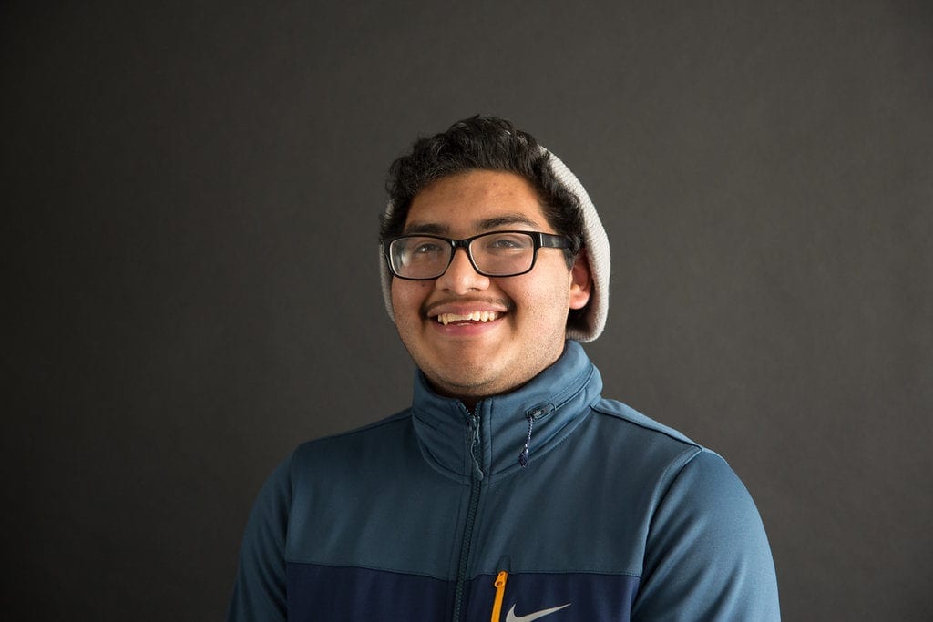 Profile of young Latino man smiling