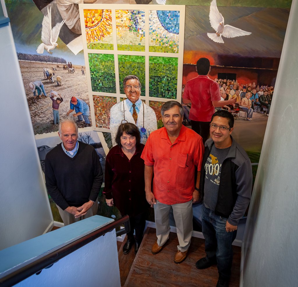 Dr. Ramon Resa, Omar Carrera and Rich Storek in front of the Empowered through Education mural