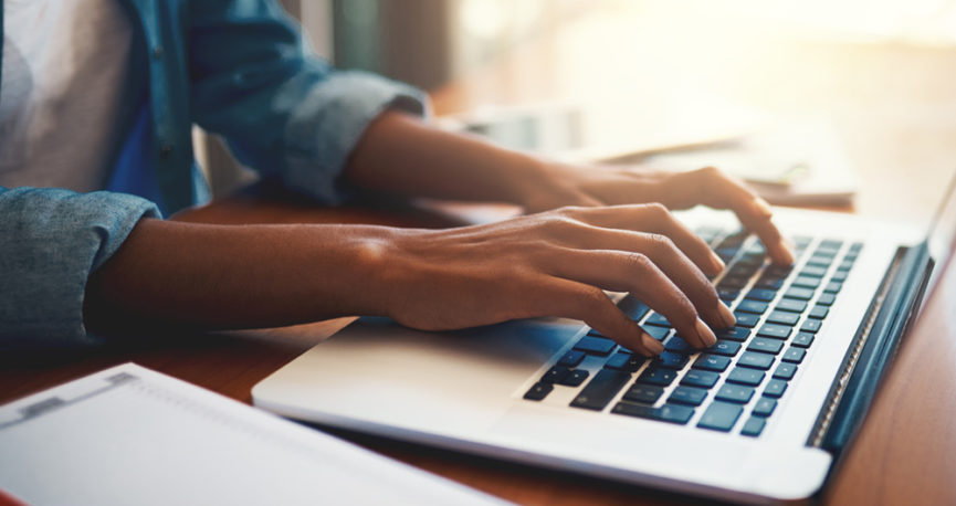This image is of a person using a laptop computer to complete their 2020 Census